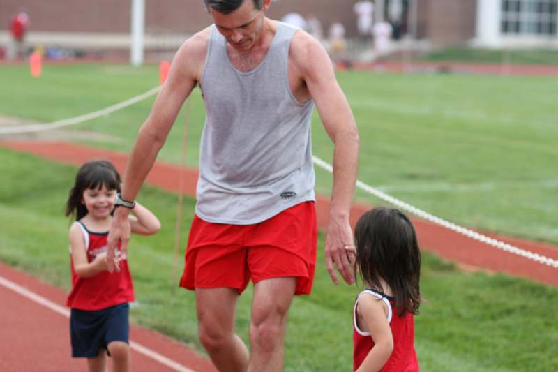 a man and two children on a track