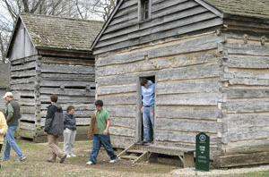 a group of people walking in a log cabin