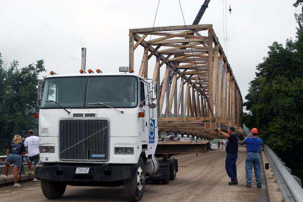 a truck carrying a wooden structure