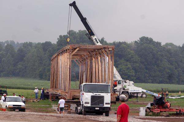 a crane lifting a wooden structure