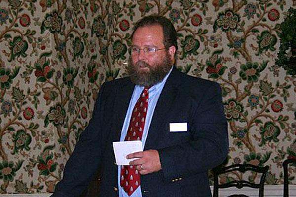 a man in a suit holding a piece of paper