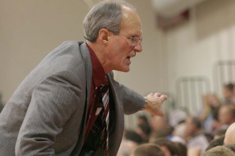 a man in a suit talking to a crowd