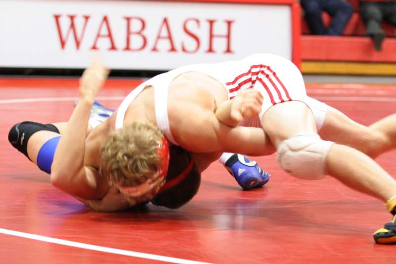 a man wrestling on a red mat
