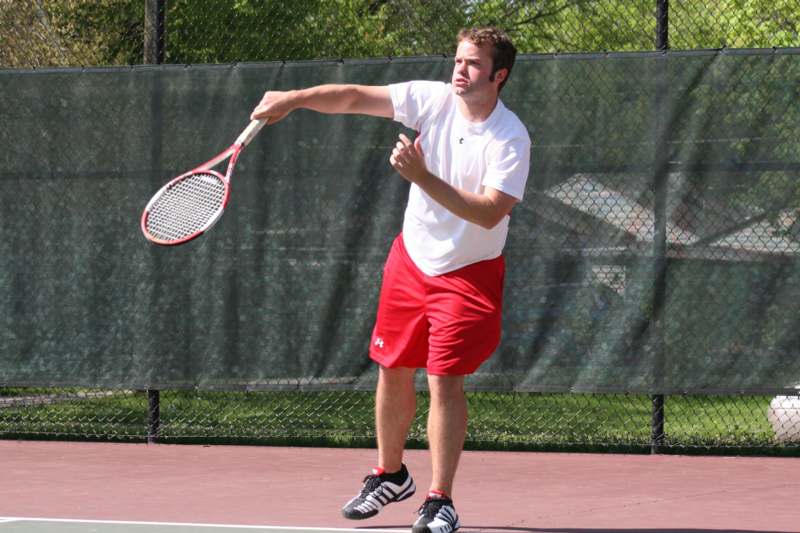 a man holding a tennis racket