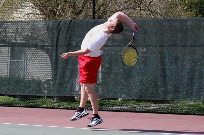 a man swinging a tennis racket