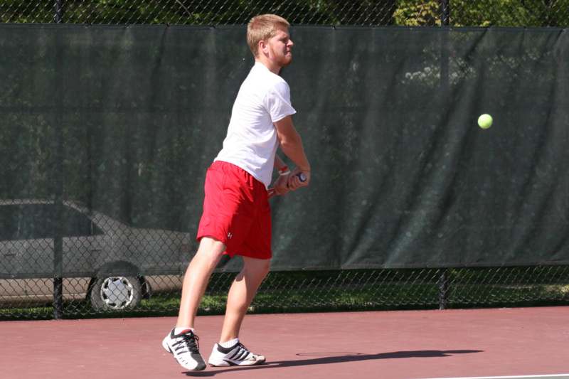 a man holding a tennis racket