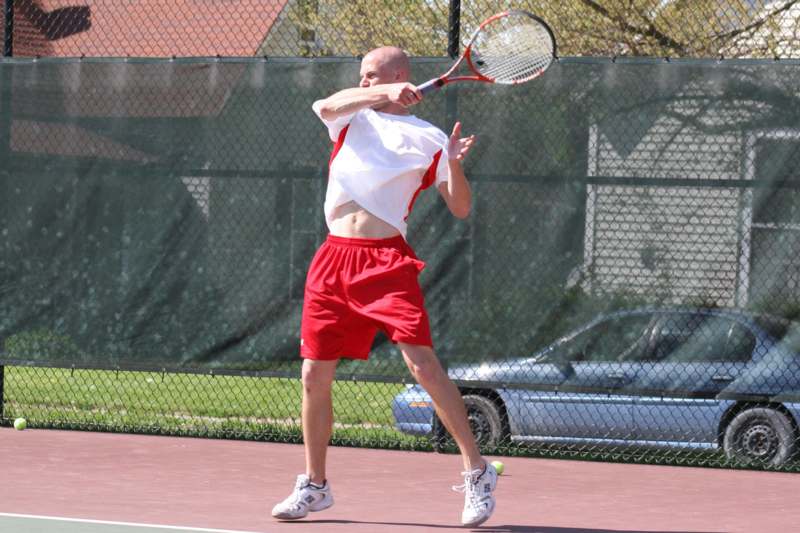 a man swinging a tennis racket