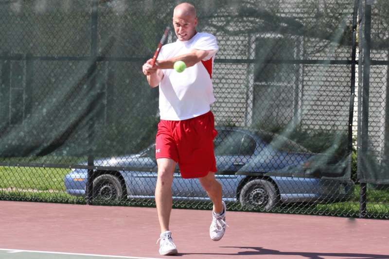 a man swinging a tennis racket