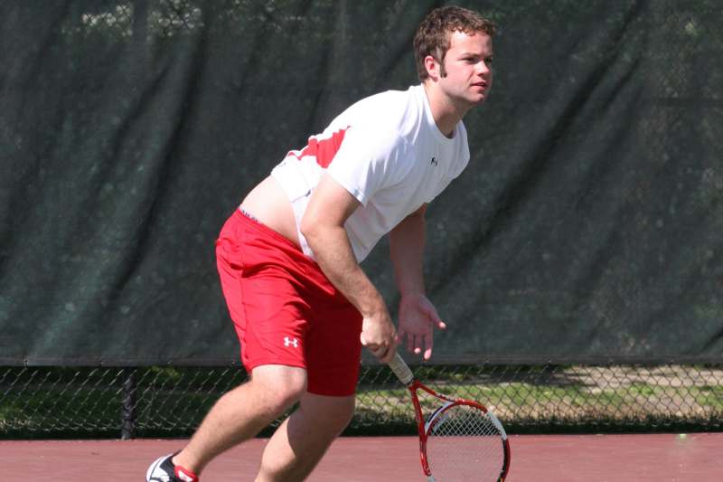 a man holding a tennis racket