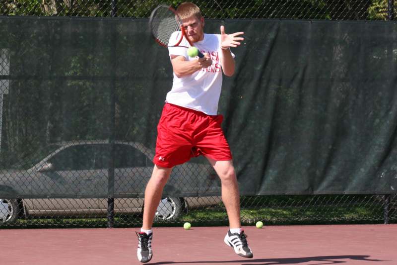 a man swinging a tennis racket
