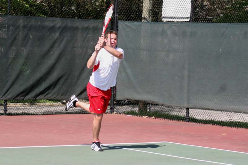 a man swinging a tennis racket