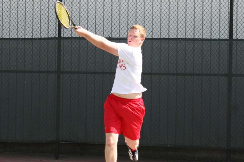 a man swinging a tennis racket