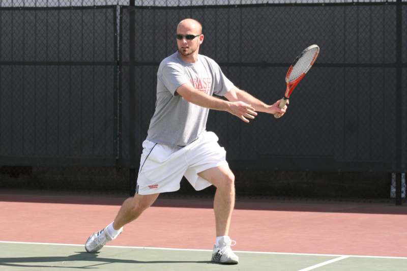a man playing tennis on a court