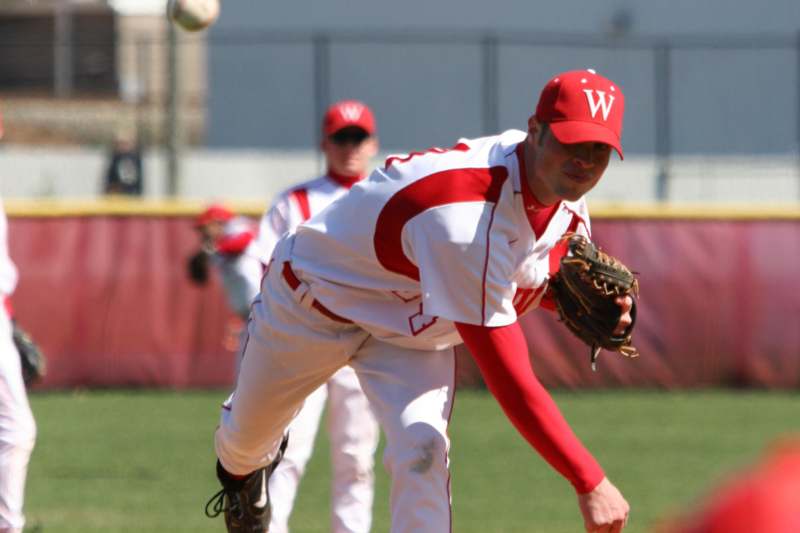 a baseball player throwing a ball