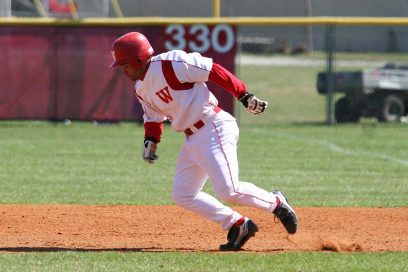 a baseball player running to first base