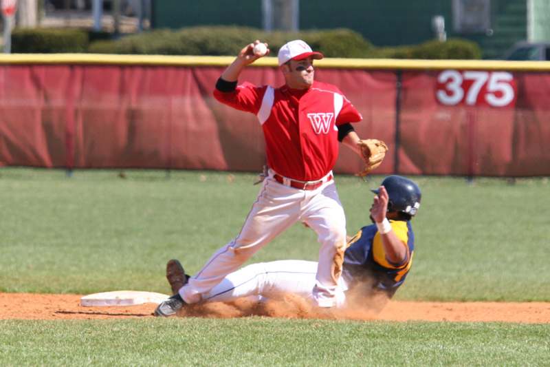 a baseball player sliding into base