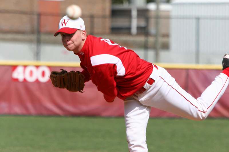 a man throwing a baseball