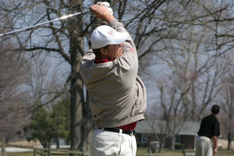a man swinging a golf club