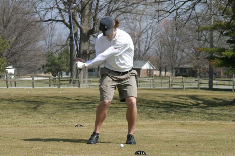 a man playing golf on a golf course