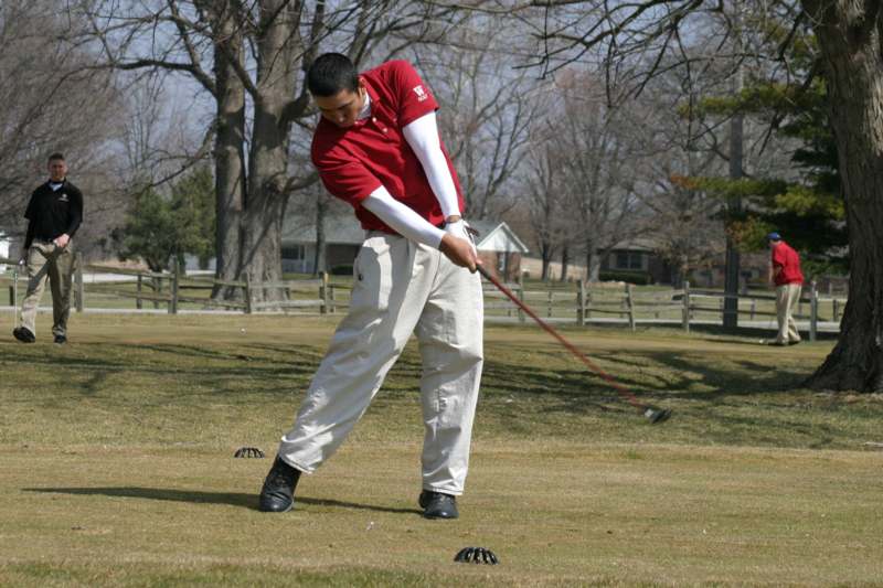 a man playing golf on a golf course