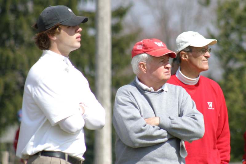 a group of men standing on a field