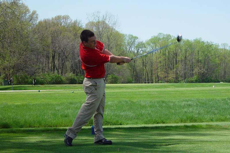 a man swinging a golf club