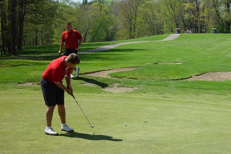 a man playing golf on a golf course