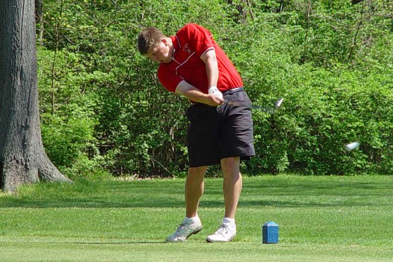 a man swinging a golf club