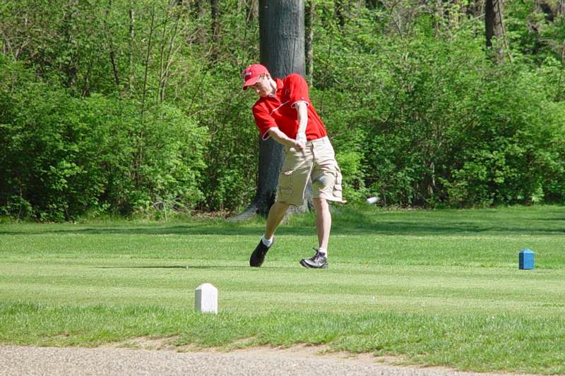 a man swinging a golf club