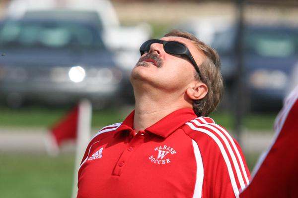 a man wearing sunglasses and a red shirt