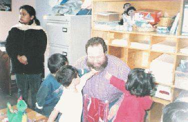 a man and children playing in a room