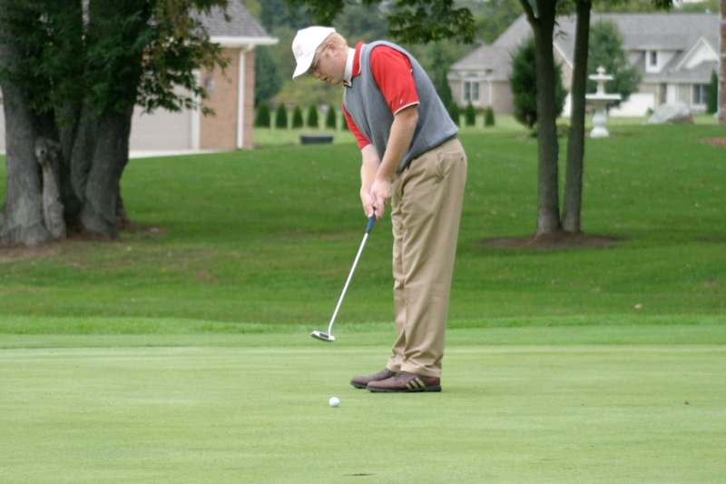 a man playing golf on a golf course