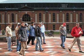 a group of people walking on a brick courtyard