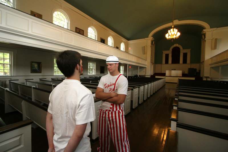 a man in striped pants standing in a church