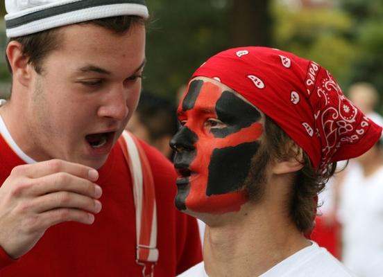 a man with face paint and red bandana