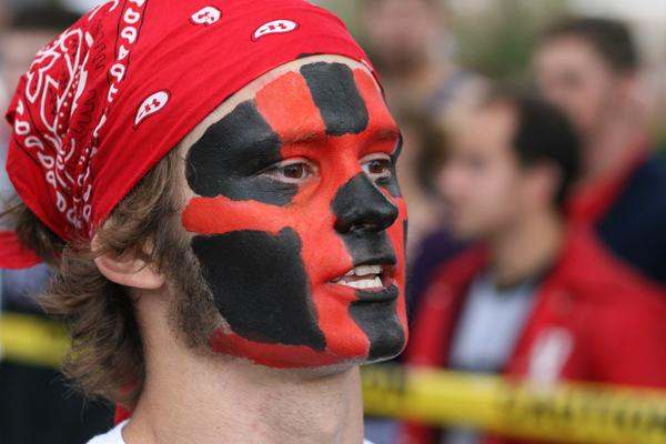 a man with red bandana and black face paint