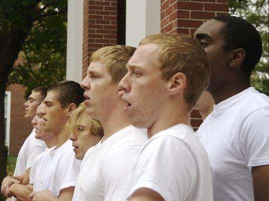 a group of men in white shirts