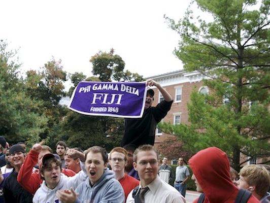 a group of people outside holding a banner