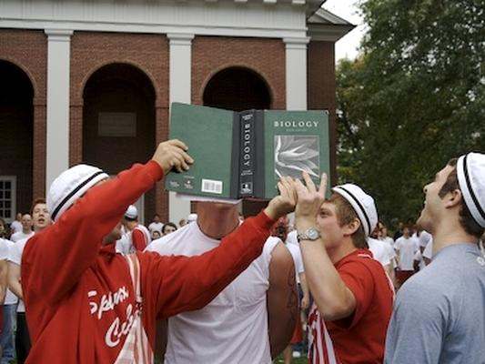 a group of people holding a book