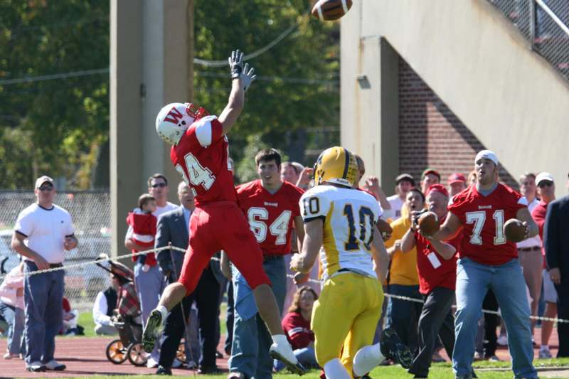 a football player jumping for a ball