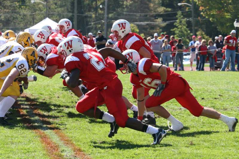 a group of football players running on a field