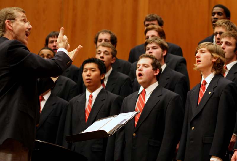 a group of men in suits singing