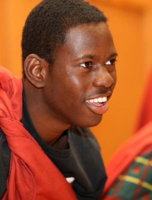 a man smiling with a red jacket
