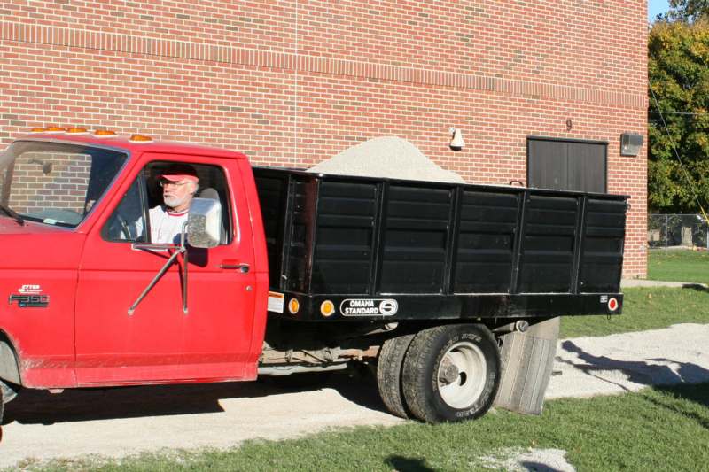 a man driving a red truck