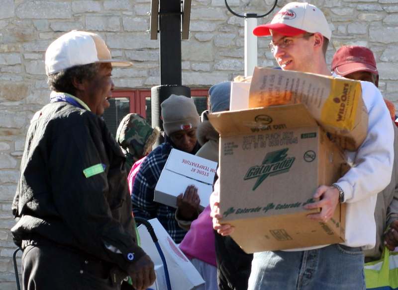 a group of people carrying boxes