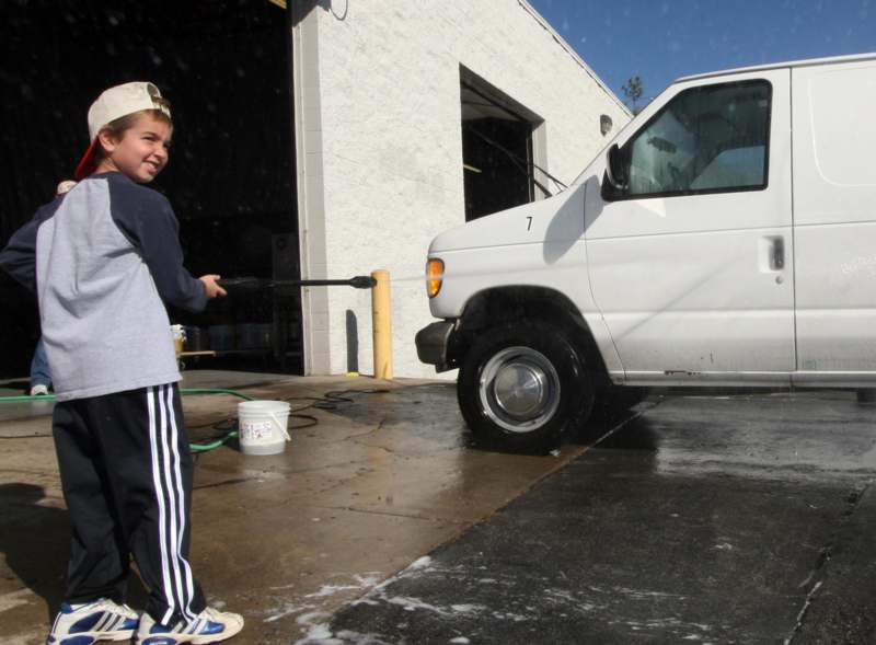a boy washing a van