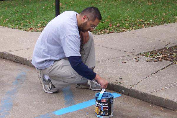 a man painting a street