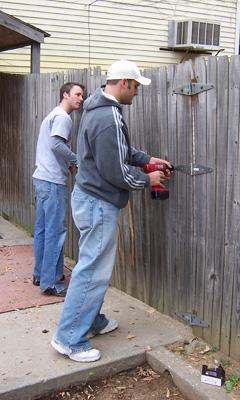 a man using a power tool to cut a wood wall