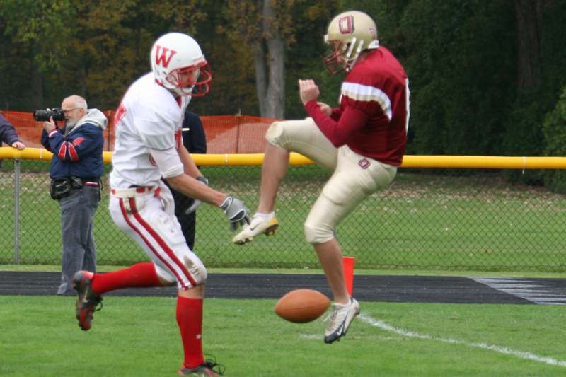a football player kicking a football