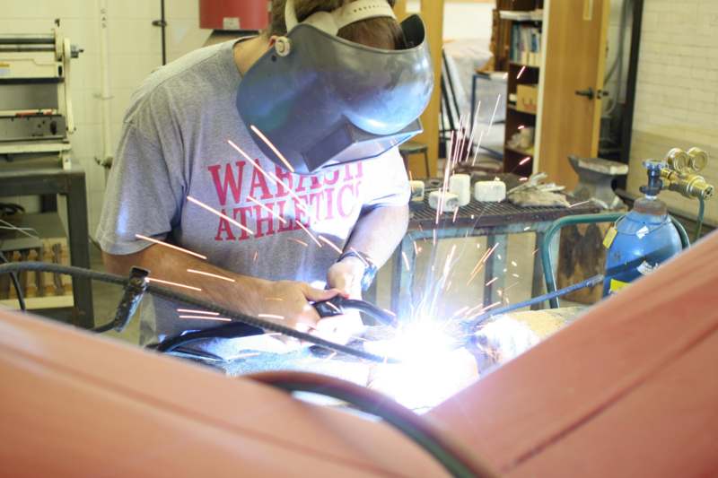 a man welding a metal piece
